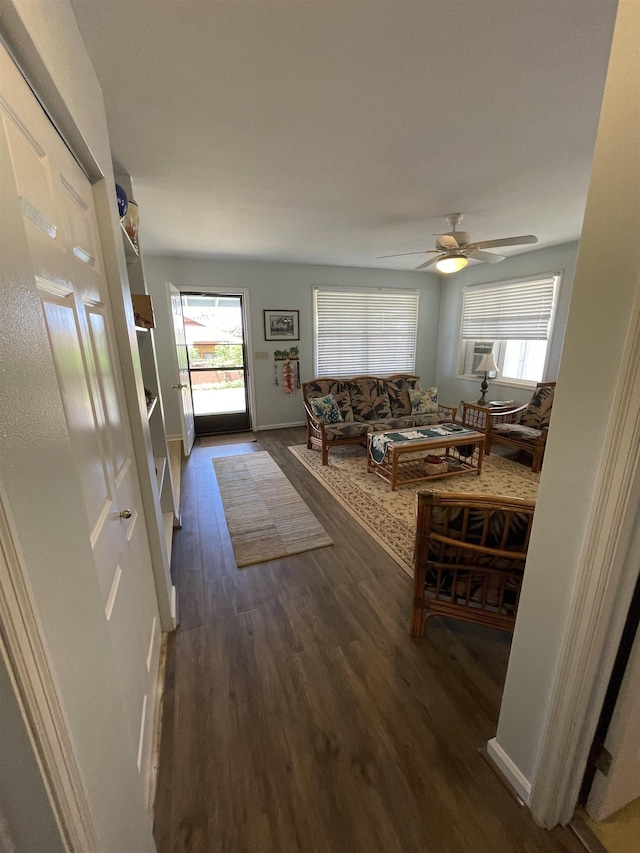 living area featuring ceiling fan, wood finished floors, and baseboards