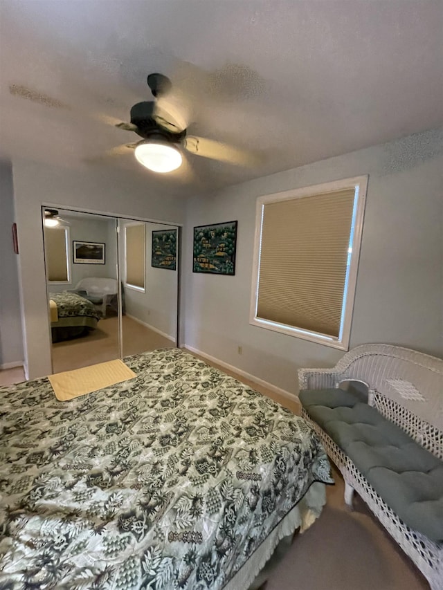 bedroom with baseboards, a ceiling fan, and a closet