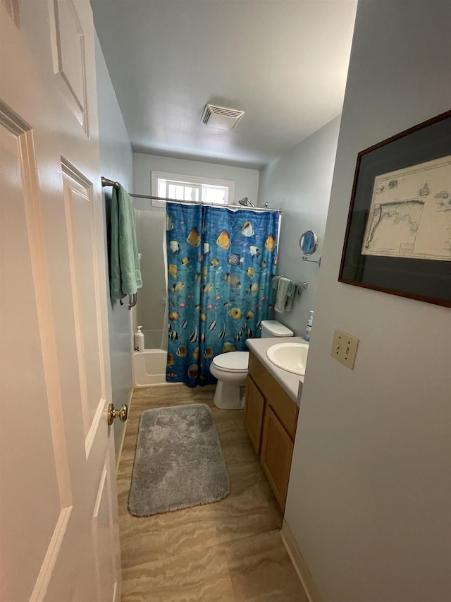 bathroom with toilet, wood finished floors, vanity, visible vents, and shower / bath combination with curtain