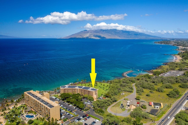 drone / aerial view featuring a water and mountain view