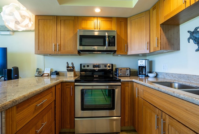 kitchen featuring light stone countertops and appliances with stainless steel finishes