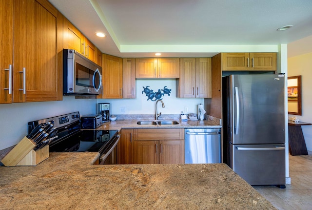 kitchen featuring stone countertops, sink, light tile patterned floors, and stainless steel appliances