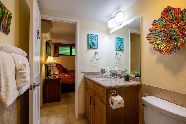 bathroom featuring tile patterned floors, vanity, and toilet