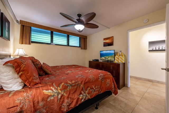 tiled bedroom featuring ceiling fan