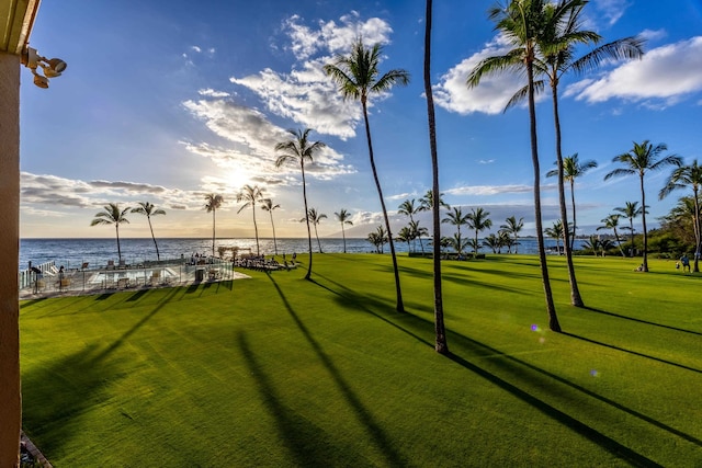 view of property's community featuring a water view and a yard