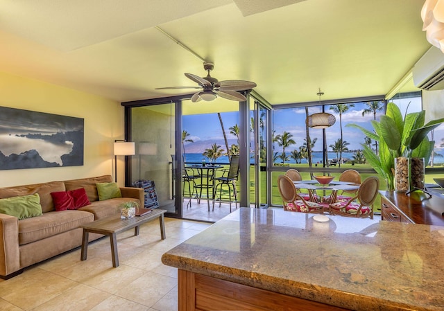 tiled living room featuring ceiling fan, floor to ceiling windows, and a wall unit AC