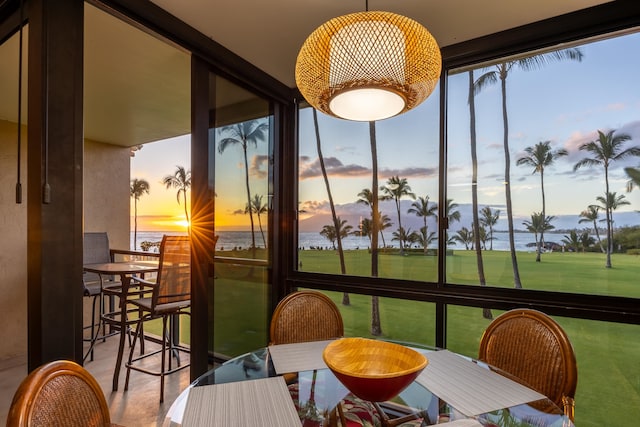 sunroom / solarium with a water view