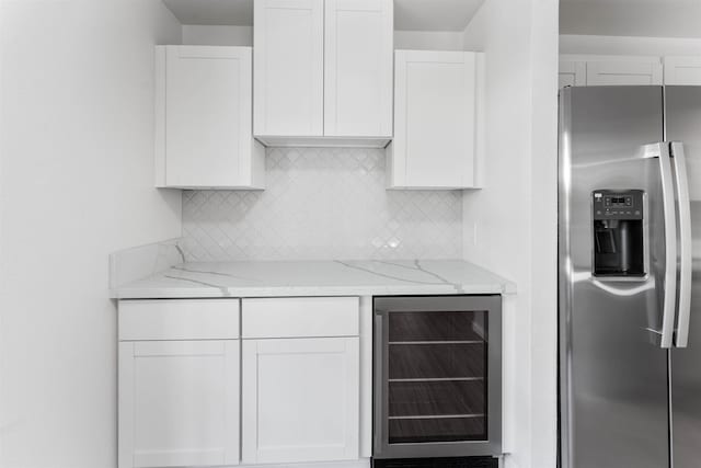 kitchen featuring beverage cooler, white cabinets, and stainless steel fridge with ice dispenser