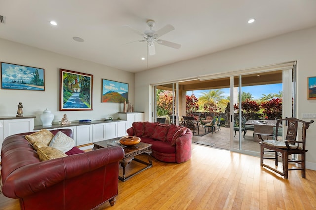 living room with ceiling fan and light hardwood / wood-style floors