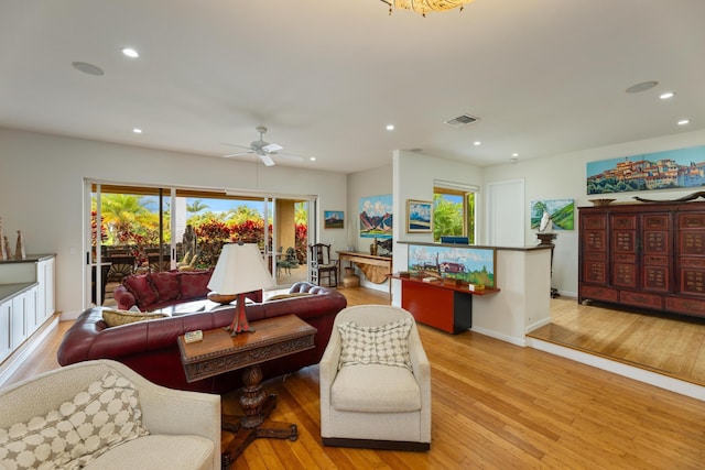 living room with ceiling fan and light hardwood / wood-style flooring