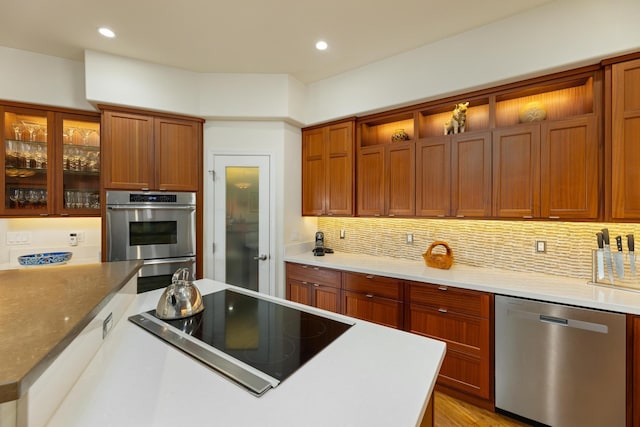 kitchen featuring appliances with stainless steel finishes and decorative backsplash