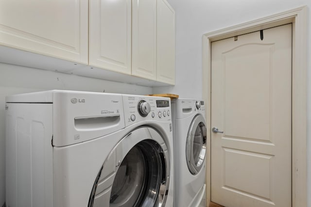 laundry area featuring cabinets and washing machine and clothes dryer