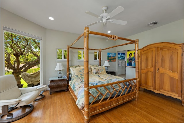 bedroom with ceiling fan and light hardwood / wood-style floors