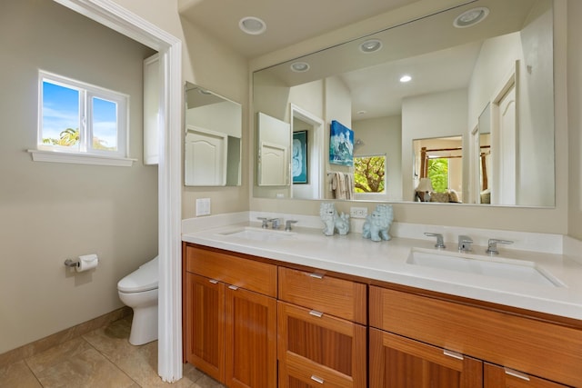 bathroom with tile patterned flooring, vanity, and toilet