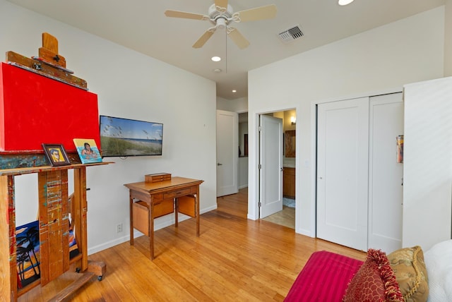 bedroom featuring hardwood / wood-style floors, a closet, and ceiling fan