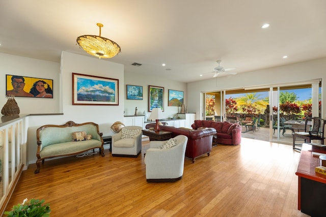 living room featuring ceiling fan and light hardwood / wood-style floors