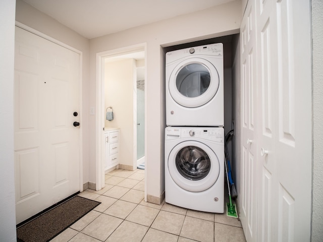 2747 S Kihei Rd Unit C004, Kihei, HI 96753 - laundry room with stacked washing machine and dryer, light tile patterned floors, and baseboards