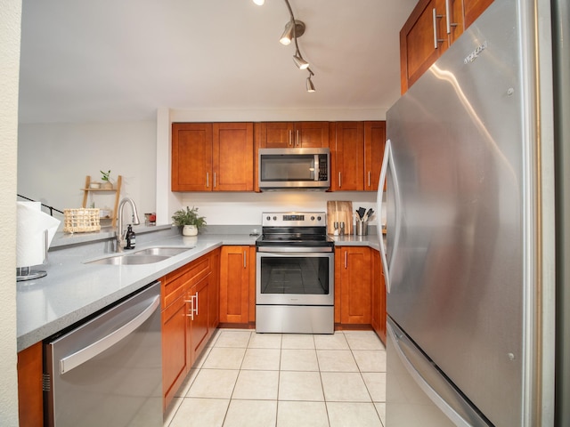 2747 S Kihei Rd Unit C004, Kihei, HI 96753 - kitchen with appliances with stainless steel finishes, a sink, brown cabinets, and light tile patterned flooring