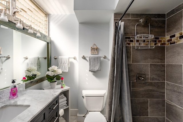 bathroom featuring toilet, vanity, and curtained shower