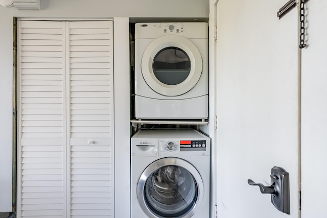 laundry room with stacked washing maching and dryer