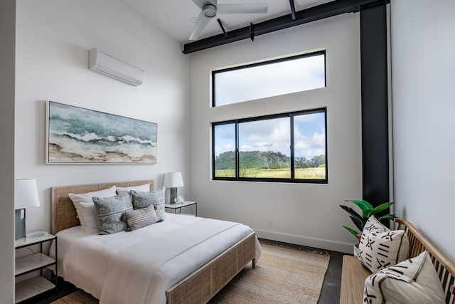 bedroom with hardwood / wood-style floors, a towering ceiling, and an AC wall unit