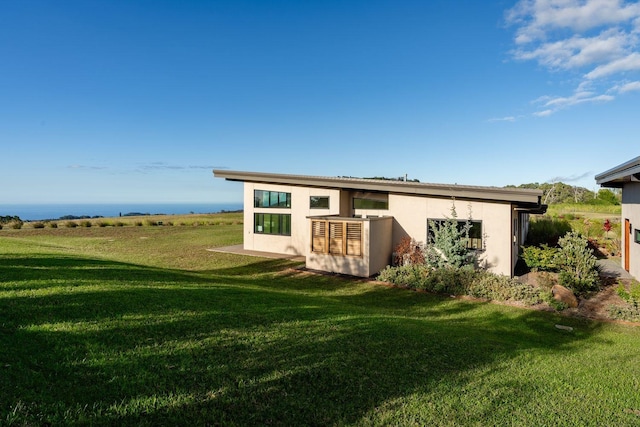 back of property with a lawn