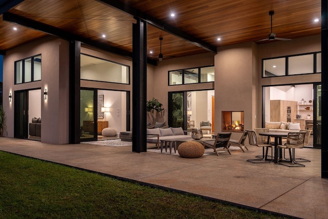 interior space featuring an outdoor living space, a patio, and ceiling fan