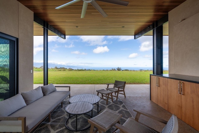 view of patio with an outdoor living space and ceiling fan