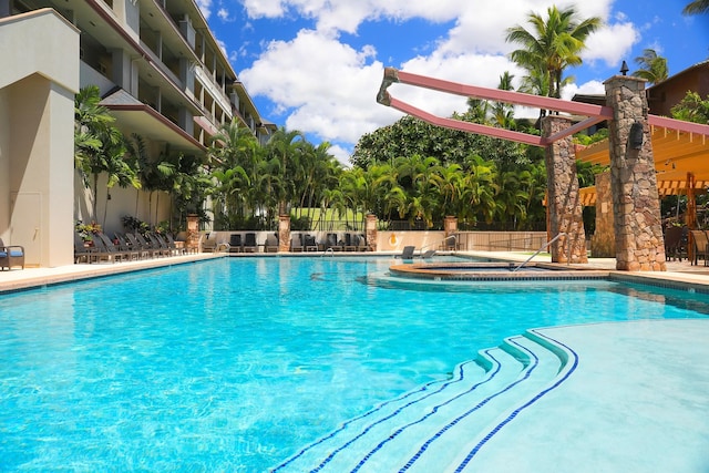 view of swimming pool with a jacuzzi