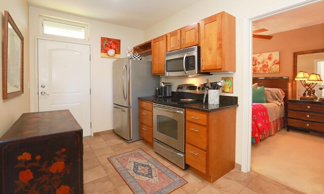 kitchen with light tile patterned floors and stainless steel appliances