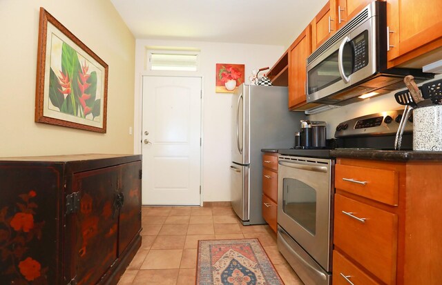 kitchen with light tile patterned floors and appliances with stainless steel finishes