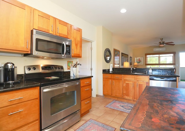 kitchen featuring stainless steel appliances, wooden counters, light tile patterned flooring, ceiling fan, and an AC wall unit