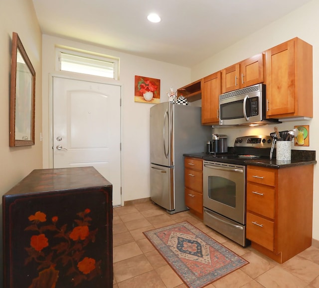 kitchen featuring light tile patterned floors and stainless steel appliances