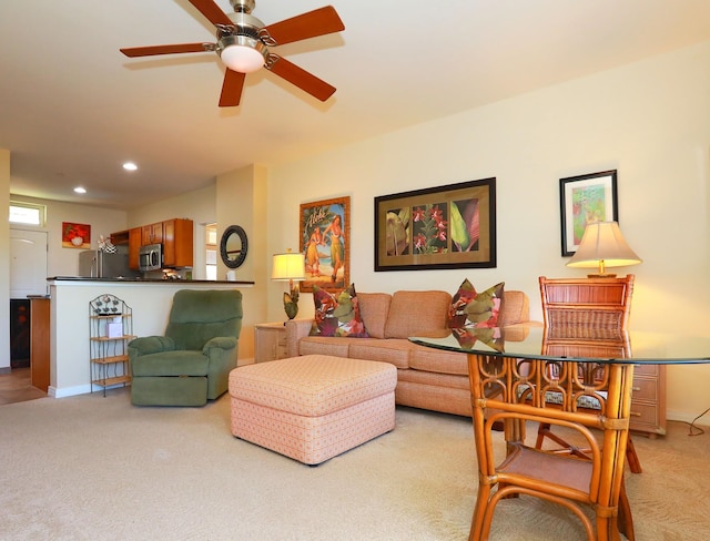 living room with light carpet and ceiling fan