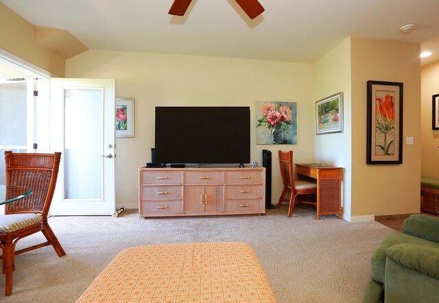 carpeted living room with lofted ceiling and ceiling fan