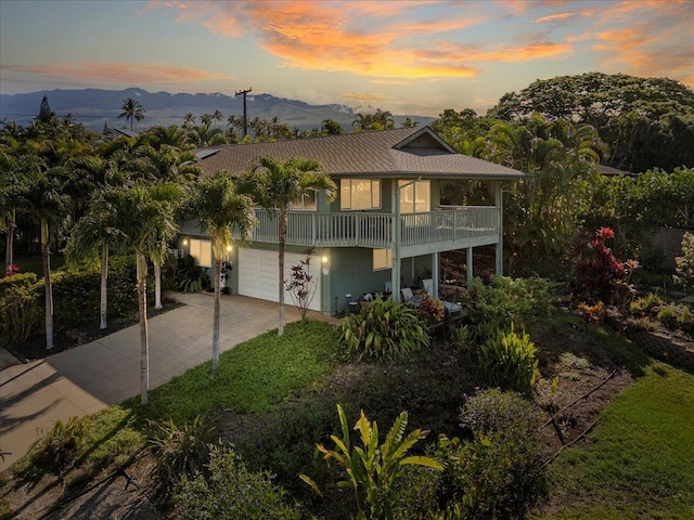 view of front of house with a balcony, a garage, and a mountain view