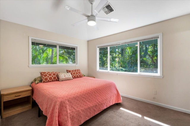 bedroom with dark colored carpet and ceiling fan