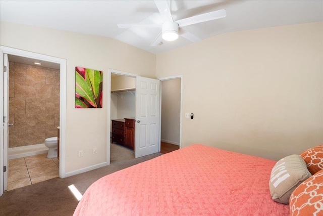 bedroom with lofted ceiling, connected bathroom, carpet floors, a spacious closet, and a closet