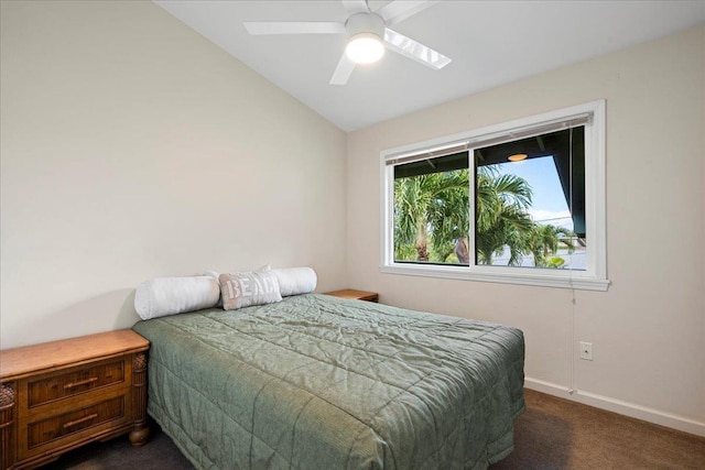 bedroom with dark carpet and vaulted ceiling