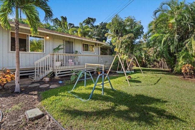 exterior space with a wooden deck, a yard, and a playground