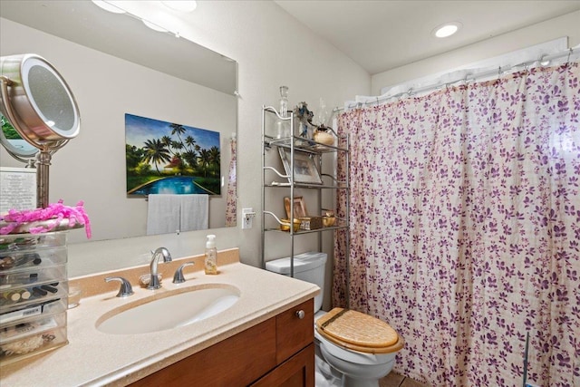 bathroom featuring vanity, toilet, and curtained shower