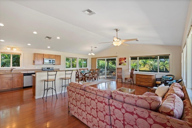 living room with sink, dark wood-type flooring, and vaulted ceiling