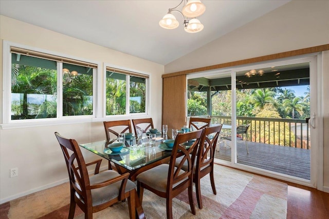 dining room featuring vaulted ceiling, a chandelier, and plenty of natural light