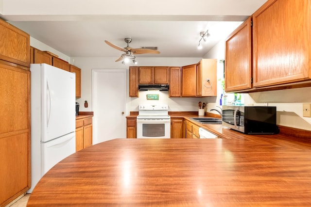 kitchen featuring ceiling fan, under cabinet range hood, white appliances, a sink, and visible vents