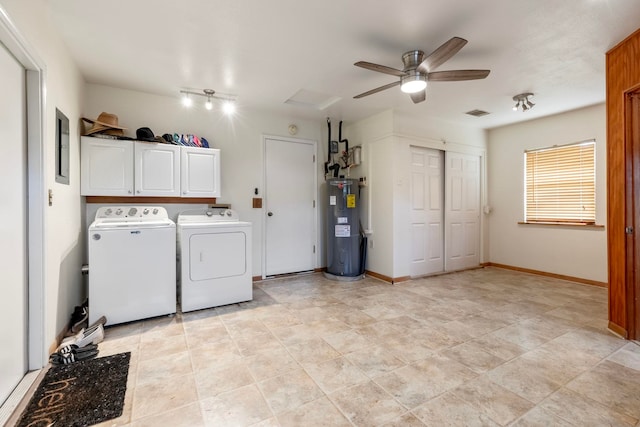 clothes washing area with electric water heater, independent washer and dryer, cabinet space, and baseboards