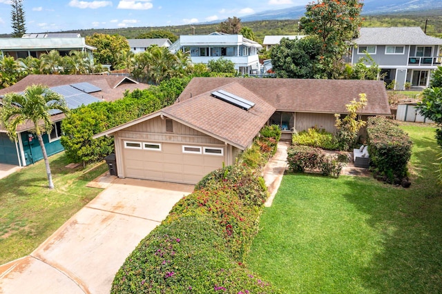 view of front of property with driveway, a front lawn, and a residential view