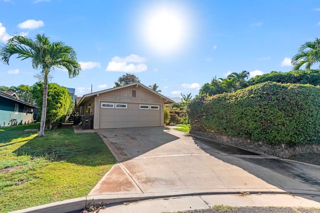 garage featuring concrete driveway