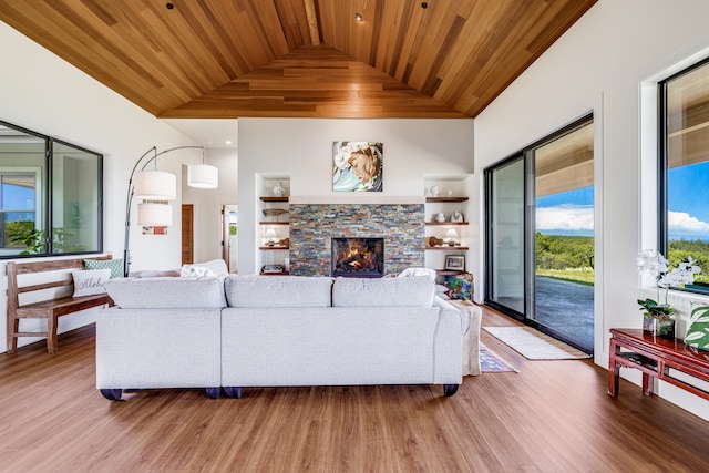 living room with wood-type flooring, wood ceiling, a fireplace, and high vaulted ceiling