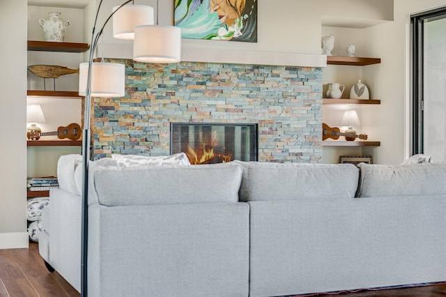 living room with dark hardwood / wood-style floors and a fireplace