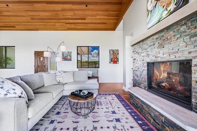 living room with hardwood / wood-style flooring, a fireplace, and wooden ceiling